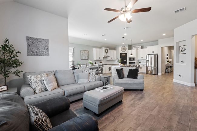 Living area featuring recessed lighting, a ceiling fan, visible vents, baseboards, and light wood finished floors | Image 21