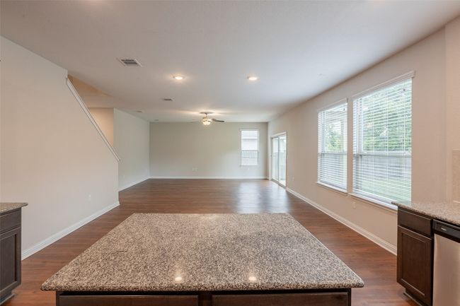 Unfurnished living room featuring visible vents, recessed lighting, dark wood finished floors, and ceiling fan | Image 6