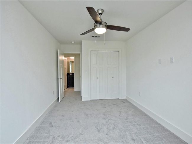 Unfurnished bedroom featuring light colored carpet, a closet, and ceiling fan | Image 17