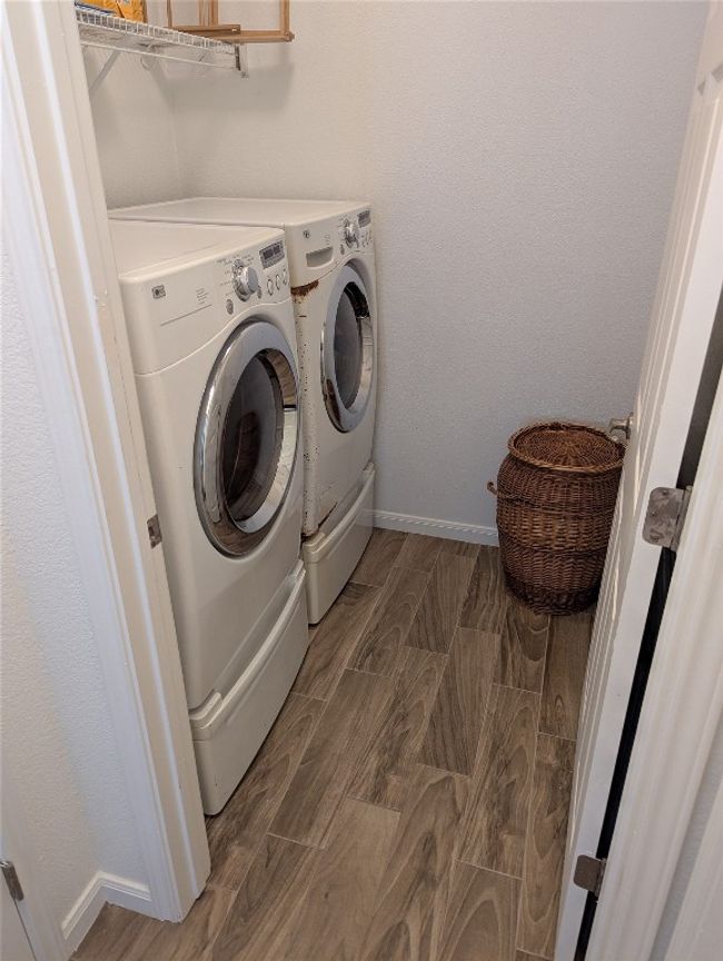 Washroom with independent washer and dryer, wood finish floors, and baseboards | Image 20