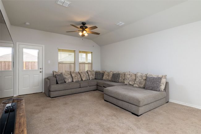 Living room featuring carpet flooring, ceiling fan, and lofted ceiling | Image 15