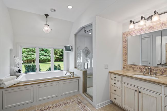 Bedroom with a raised ceiling, carpet floors, vaulted ceiling, and ornamental molding | Image 19