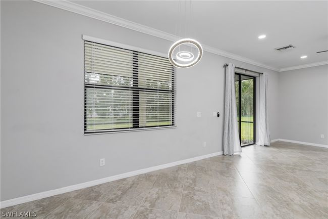 Tiled empty room featuring ornamental molding | Image 10