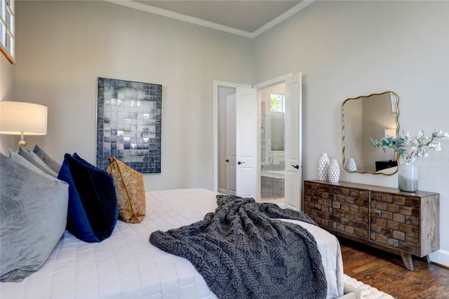 Bedroom with ornamental molding, ensuite bath, and wood finished floors. | Image 12