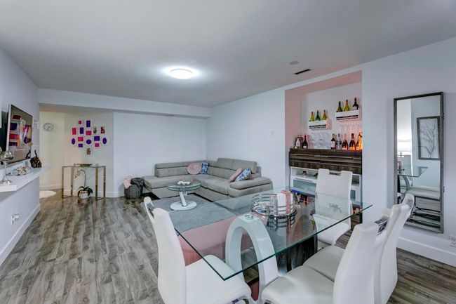 Living area featuring wood finished floors, visible vents, and baseboards | Image 25