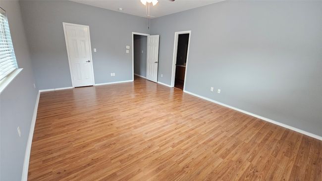 Unfurnished room with light wood finished floors and a ceiling fan | Image 6