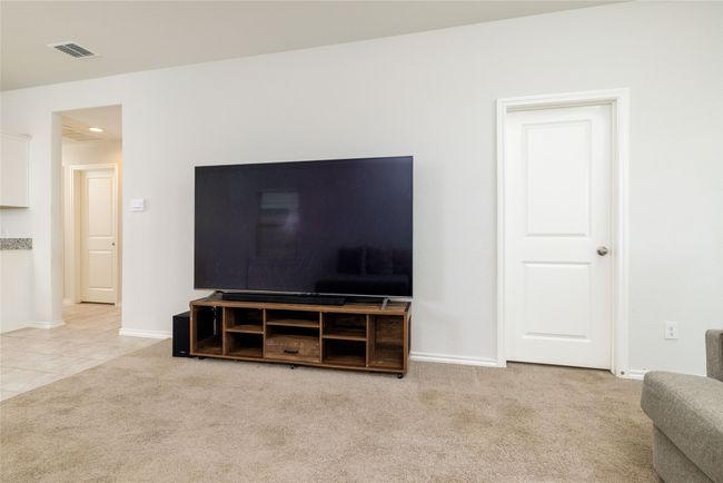 Carpeted living room with baseboards and recessed lighting | Image 18