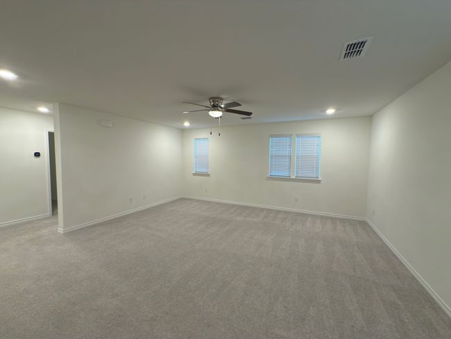 Spare room with ceiling fan, recessed lighting, light colored carpet, and baseboards | Image 32
