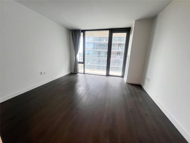 Spare room with dark wood-style floors and floor to ceiling windows | Image 6