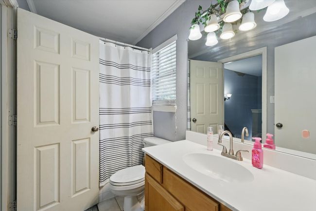 Full bath with vanity, crown molding, and curtained shower | Image 28
