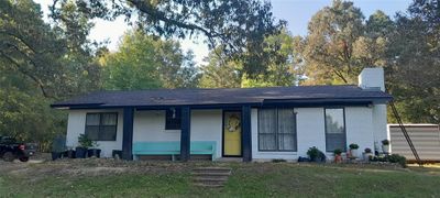 View of front of home featuring a front yard and covered porch | Image 1