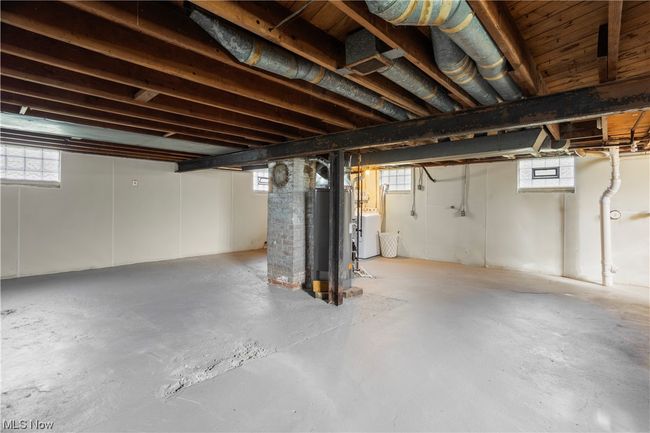 Basement featuring plenty of natural light and gas water heater | Image 29