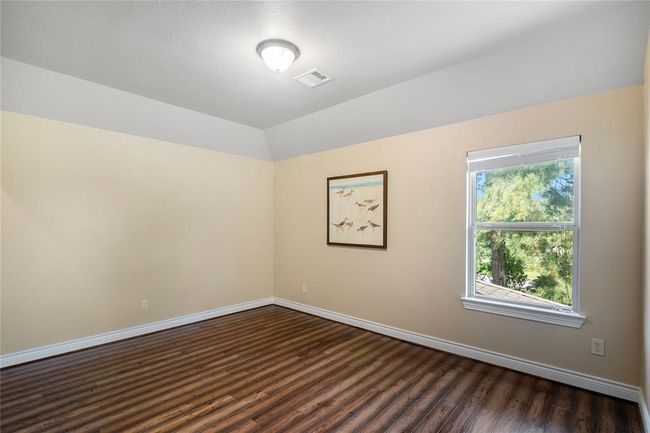 The third generous secondary bedroom with a view to the backyard. | Image 33
