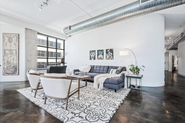 Living area featuring stained concrete floors and views over 5th street. | Image 15