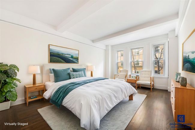 Bedroom featuring baseboards, dark wood-type flooring, and beamed ceiling | Image 4