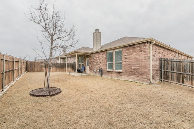 Rear view of house with a yard and a patio area | Image 34