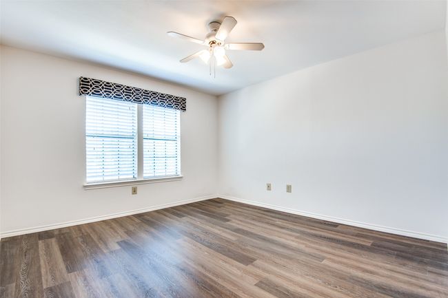 Empty room featuring ceiling fan and dark wood-type flooring | Image 8