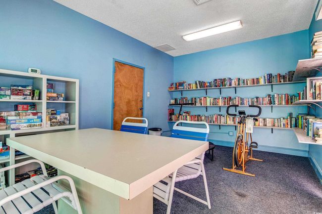 Carpeted home office with a textured ceiling | Image 34