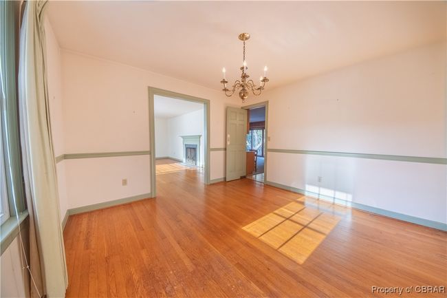Unfurnished room featuring an inviting chandelier and light wood-type flooring | Image 17