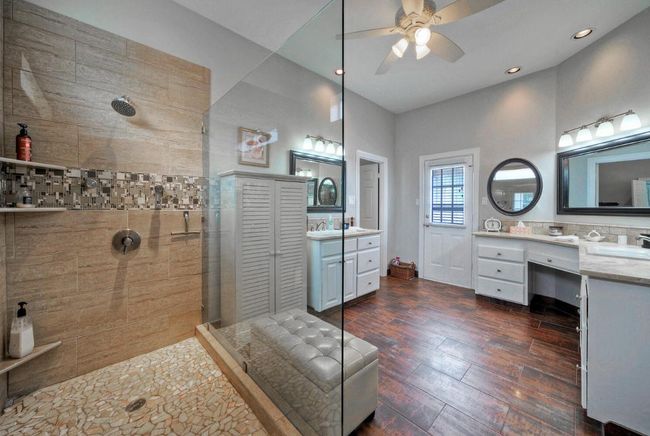 Bathroom featuring recessed lighting, a walk in shower, wood finished floors, vanity, and a ceiling fan | Image 20