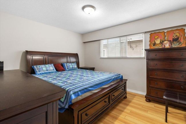 Bedroom featuring baseboards, light wood-type flooring, and a textured ceiling | Image 18