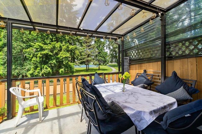 View of patio / terrace featuring a deck and outdoor dining space | Image 34