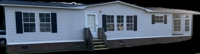 View of home's exterior featuring crawl space and entry steps | Image 9