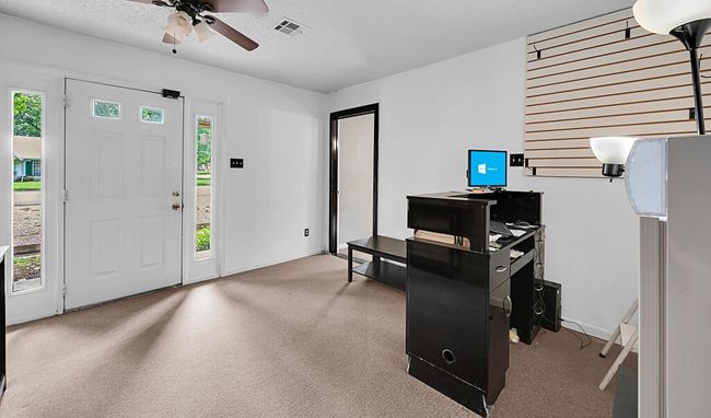 Carpeted entryway featuring a ceiling fan, healthy amount of natural light, and baseboards | Image 4