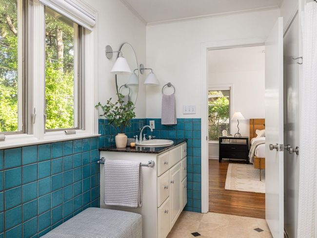 Bathroom with vanity, tile patterned floors, and a shower / bath combo. | Image 16
