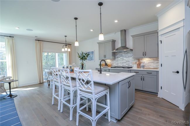 Kitchen with granite countertops, gas cooking, island, pantry, stainless steel appliances and LED recessed lighting. | Image 7