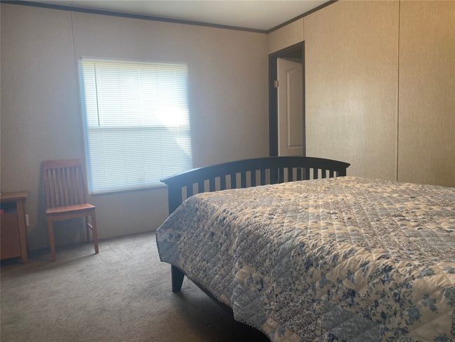 Bedroom with carpet floors and crown molding | Image 10