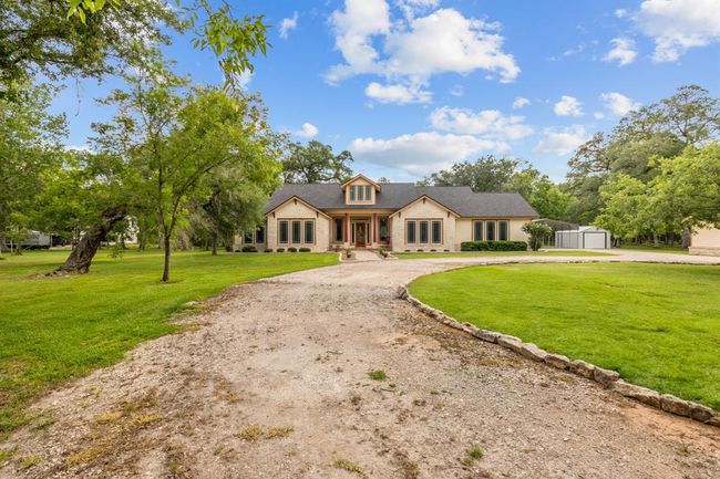 Wide-angle view illustrates the home’s generous footprint and adjacent carport/storage shed, perfect for RVs, boats or workshop space. | Image 4