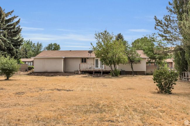 Back of property with stucco siding and central AC unit | Image 32