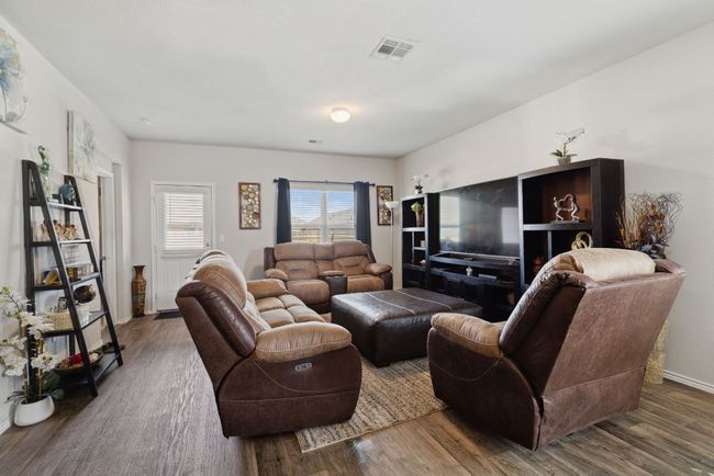 Living area with wood-vinyl finished floors and baseboards | Image 21