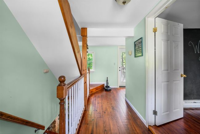 Corridor featuring hardwood / wood-style floors, baseboards, and an upstairs landing | Image 9