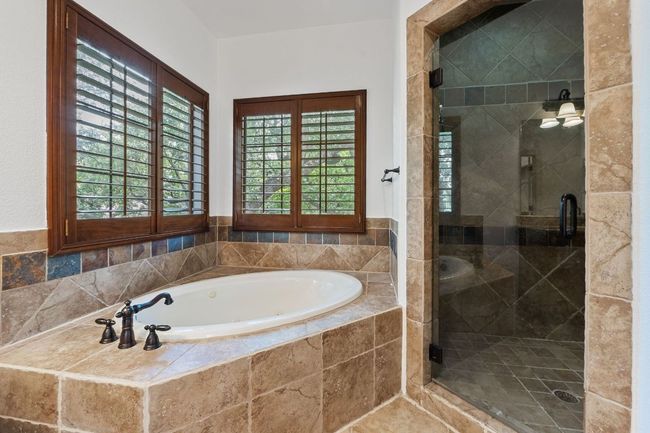 Full bathroom featuring a garden tub and a shower stall | Image 33
