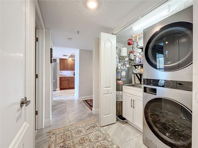 Laundry includes utility sink and water heater | Image 37