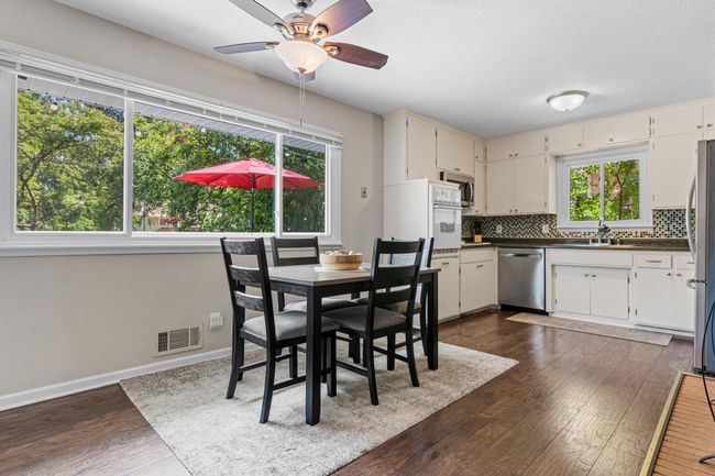 Large kitchen and dining room with a beautiful picture window view of the amazing backyard. | Image 7