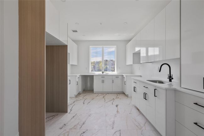 Kitchen with modern cabinets, visible vents, marble finish floor, and a sink | Image 14