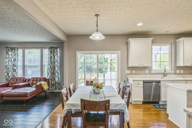 dining space featuring a textured ceiling, light wood-style flooring, and recessed lighting | Image 16