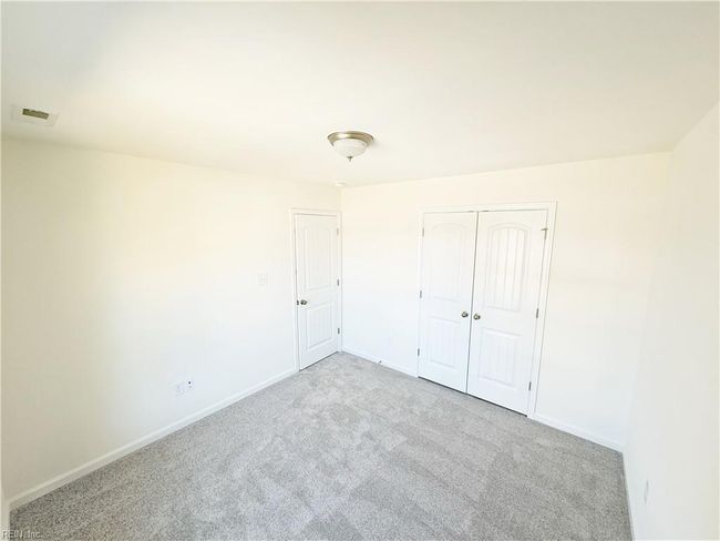 Upstairs you’ll find two additional bedrooms with carpet and double door closets. | Image 13