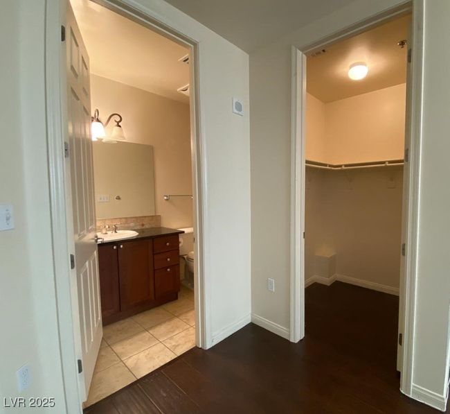 Bathroom featuring vanity, wood finished floors, and a walk in closet | Image 15