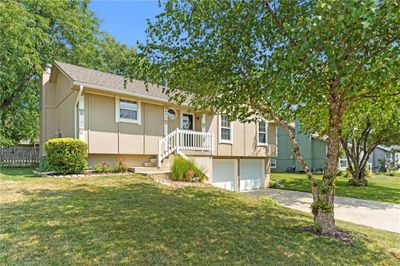 View of front of house featuring a front yard and a garage | Image 2