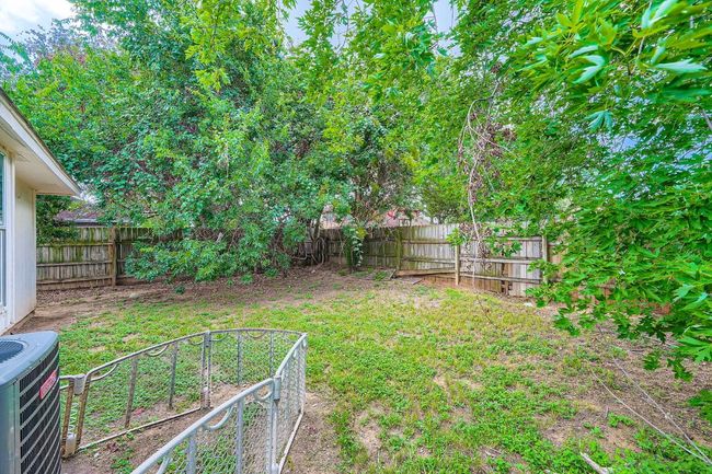 View of fenced backyard | Image 25