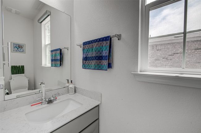 Bathroom with toilet, vanity, and visible vents | Image 16