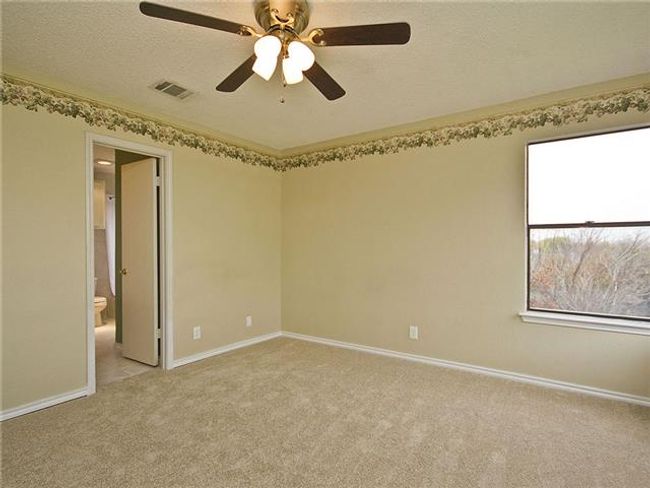Empty room with baseboards, visible vents, light carpet, and ceiling fan | Image 10