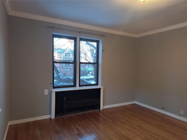 Unfurnished room featuring ornamental molding, baseboards, and wood finished floors | Image 36