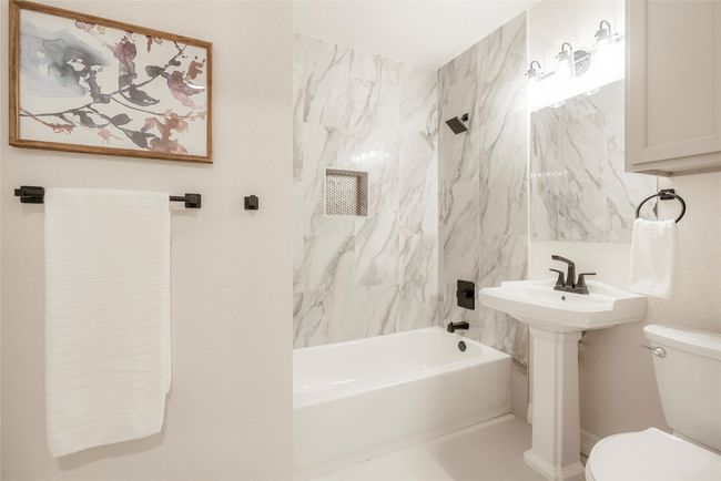 Bathroom featuring toilet and tub / shower combination | Image 23
