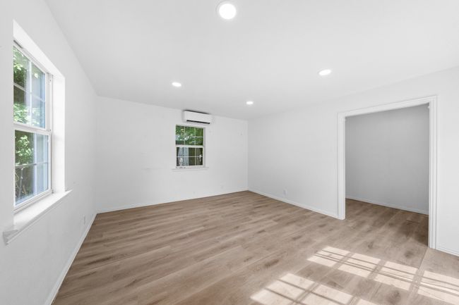 Spare room / Workshop with a wall mounted AC, recessed lighting, light wood finished floors, and baseboards | Image 25