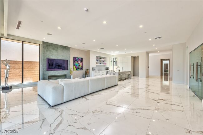 Living room featuring a large fireplace, recessed lighting, and visible vents | Image 5